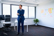 © baranq - Pensive businessman standing in office