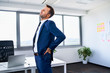 © baranq - Lower back pain. Businessman stretches in office.