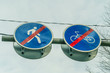 © yaroslav1986 - Two road signs side by side for pedestrians and cyclists close up against the sky and tree branches showing that the drive and pass is over