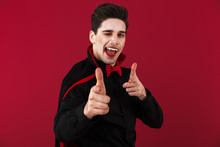 Image Of Pleased Vampire Man In Black Halloween Costume Pointing Finger