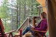 glamping trip - woman sitting and relaxing outside luxury tent in Montana