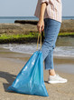 © Freepik - Woman holding garbage bag with recyclable plastic bottle