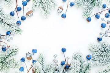 christmas composition with holly berries, snowflake and green fir branch on white background. xmas f