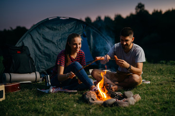 Wall Mural - campers outdoor camping by the river barbecuing