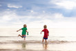 © famveldman - Kids play on tropical beach. Sand and water toy.