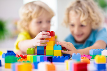 Child playing with toy blocks. Toys for kids.