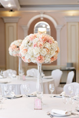 Poster - A large composition from an assortment of beautiful flowers elegantly adorns the dining table