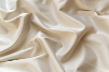 Smooth elegant pearl white silk fabric in luxury beige, cream or ivory color texture background