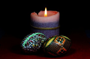 traditional arrangement for Easter with a candle and two eggs