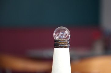 Bottle of beer with bubble on the top against the blured background