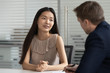 © fizkes - Asian woman vacancy candidate answering question during job interview