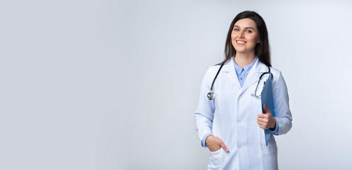 Wall Mural - Confident Doctor Woman Smiling At Camera Standing, Studio Shot, Panorama