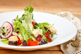 Fototapeta Tulipany - vegetarian salad with dried tomatoes and croutons on the wooden background
