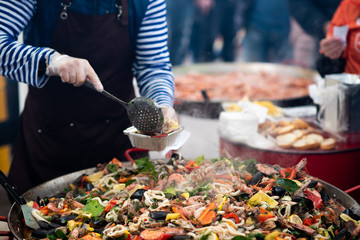 cooking vegetables. Stewing vegetables in a huge plate paella