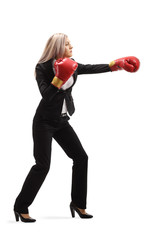 Wall Mural - Woman in a suit with boxing gloves punching