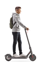 Male Student With A Backpack Riding An Electric Scooter