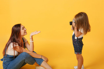 Wall Mural - Woman in light clothes have fun with cute child baby girl 4-5 years old. Mommy little kid daughter isolated on yellow background studio portrait. Mother's Day love family parenthood childhood concept.