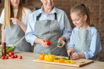 Wall Mural - Adorable girl learning how to cut vegetables