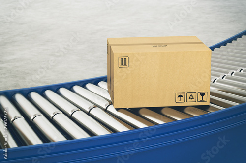 Fotografía Cardboard boxes on conveyor rollers ready to be shipped by courier for distribut