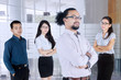 © Creativa Images - Business people stands with folded arms in office