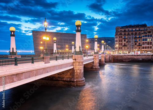 View on Zurriola bridge over Urumea river at night in San Sebastian