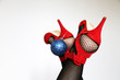 © Oleg - Christmas celebration, female legs in fishnet stockings and red shoes on high heels with a toy ball on a white background. Concept of New year outfit, romantic date