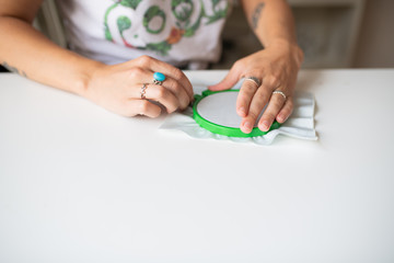 Wall Mural - Woman attaching fabric to an embroidery hoop