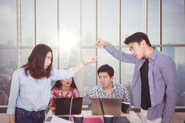 Wall Mural - Two angry workers pointing each other in meeting