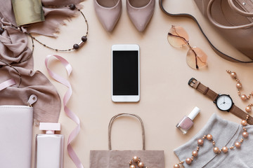 Mock up blank empty smart phone screen on beige fashion women stylish accessories outfit glamour set gifts sale flat lay background, online app shopping mobile ecommerce technology concept, top view