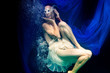 © Peter Hofstetter - model, half naked under water posing with bubbles and blue fabric