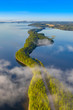 Aerial view of Pulkkilanharju Ridge, Paijanne National Park, southern part of Lake Paijanne. Landscape with drone. Fog, Blue lakes, fields and green forests from above on a sunny summer morning.