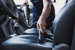 © LIGHTFIELD STUDIOS - Cropped view of car cleaner vacuuming drivers seat in car