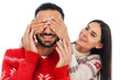 © LIGHTFIELD STUDIOS - cheerful woman covering eyes of bearded man in sweater isolated on white