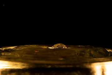 Water splash, golden water splash isolated on black background,water