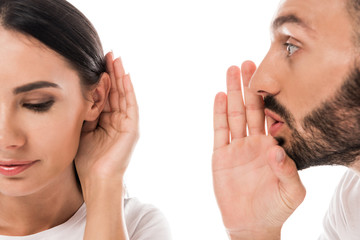 Wall Mural - handsome bearded man gossiping near woman isolated on white