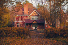 Manor House With Trees In Autumn Colors And Fall Trees. Old Victorian Haunted House With Ghosts. Abandoned House In Autumn Wood