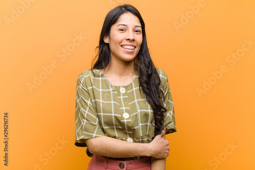 young pretty hispanic woman laughing shyly and cheerfully, with a friendly and p Tableau sur Toile