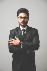 Wall Mural - Portrait of Indian Male businessman standing over white background