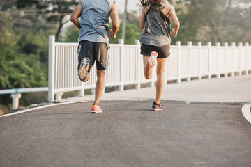 Young couple running on the street be running for exercise. fitness, sport, people, exercising ,running and lifestyle concept .