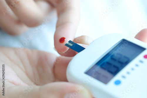 Cuadros en Lienzo hand of people check diabetes and high blood glucose monitor with digital pressure gauge