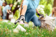 © Viktoriia - Volunteering. Young people volunteers outdoors girl in gloves close-up picking plastic cup blurred background