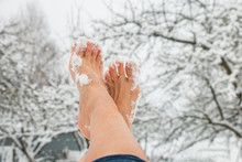 Female Bare Feet, Toes In The Snow On A Frosty Winter Day Against A Garden, Hardening The Body