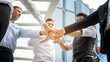 © FotoArtist - Low Angle View Of Business Coworkers Doing Fist Bump While Standing Outdoors