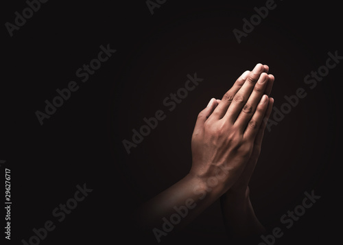 Cuadros en Lienzo Praying hands with faith in religion and belief in God on dark background