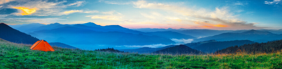 Wall Mural - orange tent on a plain in the mountains
