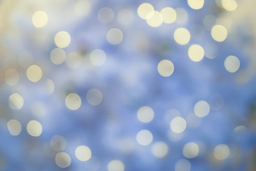 Defocused background with blurred Christmas light. New year magic bokeh lights in cold tones
