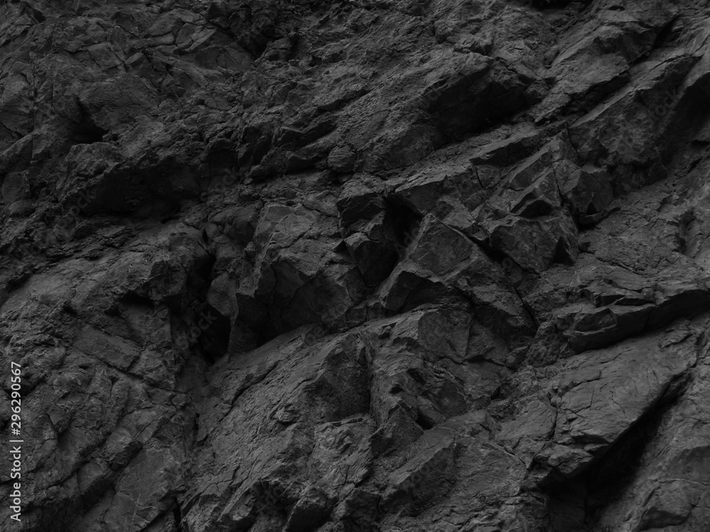    Black stone background. Mountain close-up. Fragment of the mountain.   Black rock texture.  - obrazy, fototapety, plakaty 