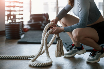 Beautiful sunlight goes through the window. Sportive young woman have fitness day in the gym at morning time