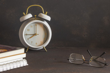 vintage alarm clock and books