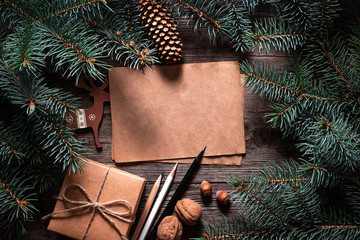 Wall Mural - A frame of fir branches and  gift paper box tied with twine. Christmas card blank.